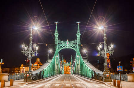 Night view of Liberty Bridge or Freedom Bridge in Budapest, Hungary, connects Buda and Pest across the River Danube.の写真素材