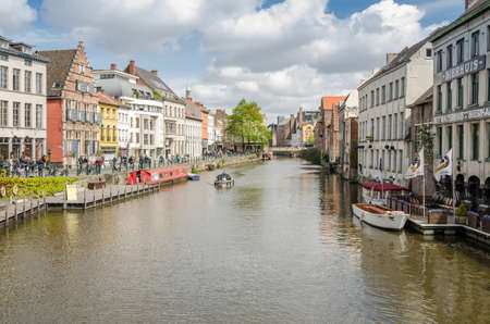 GHENT, BELGIUM - APRIL 16, 2017: View of colorful traditional houses along the canal and boats in popular touristic city of Ghent, Belgiumのeditorial素材