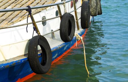 Nautical background with a ship  Tourist motorboat with mooring ropes at sea background  Aboard a boat moored in the port の写真素材