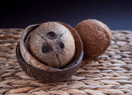 Whole cocos with buddha bowls from the coconuts shells on dark background.