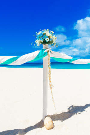 Wedding on the beach. Wedding arch decorated with flowers on tropical sand beach.の写真素材
