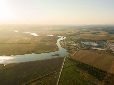 Aerial drone view, at sunset on the river among the fields. The middle band of Russia.の写真素材