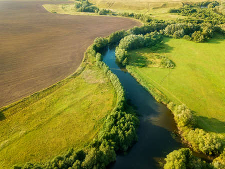 Aerial drone view of the river among the fields. The middle band of Russia.の写真素材