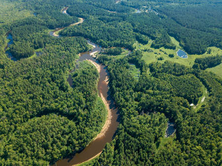 Aerial drone view, the bend of the river with sandy stretches of deep forest on a Sunny day.