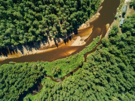 Aerial drone view, the bend of the river with sandy stretches of deep forest on a Sunny day.の写真素材