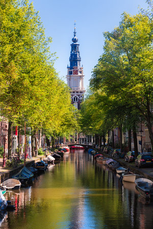 Amsterdam, Netherlands, Europe, September 1 2021 Zuiderkerk Protestant Church, traditional old narrow houses boats and canals in Amsterdam, the capital of the Netherlandsの写真素材
