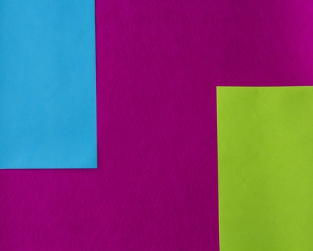 texture of few sheets of coloured paper and fuchsia background