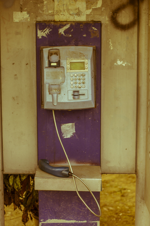 Street photo of an old payphone out of serviceの写真素材