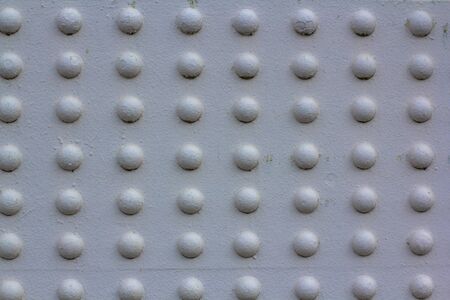 Texture of rivets massive metal construction. Attachment of the metal part of the bridge white...
