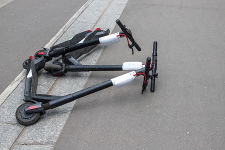 Electric rental kick scooter on the sidewalk. Eco transportation in Paris.
