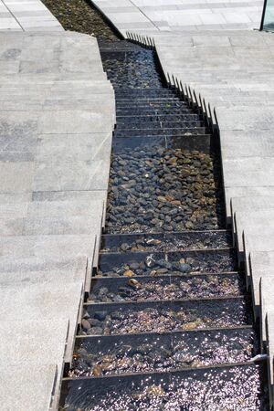 City stream. Water cascade. Steps down and in the middle, water flows down the steps. Modern...