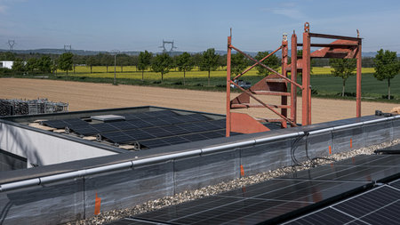 solar panels being installed on the roof of a company between town and country