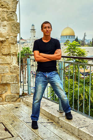 Man stands close to the wall of tears. Jerusalem Temple on background, Israel.