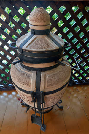 Tandyr oven close up photo on the wooden fance background. Summer, Sochiの写真素材