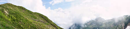 View of snow capped mountains and cloudy sky in Sochi, Summer Russia