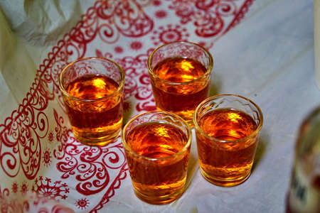 A small glasses of strong alcoholic drink, Pile of cognac