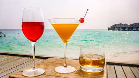 Cocktails on tropical beach vacation, sea background, Maldives