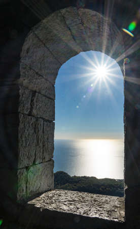 View from the tower on Akhun mountain. Sun rays over the Black Sea and bright blue sky. Sochi