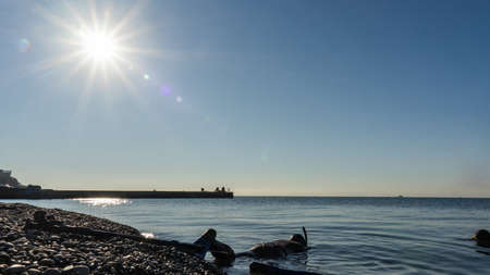 Free diver in wetsuit with flippers ready to dive into the Black sea. Sochiの写真素材