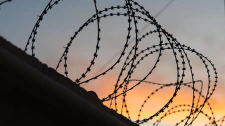 Sunset behind the barbed wire along the border. Sochi