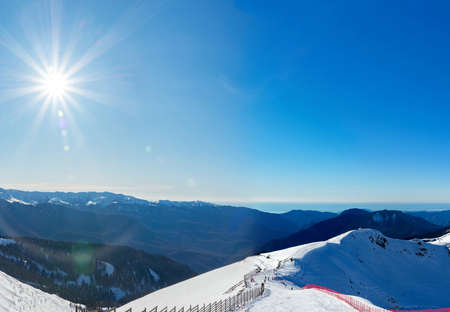 Rosa Khutor ski resort. Mountain landscape of Krasnaya Polyana and sun shining, Sochi