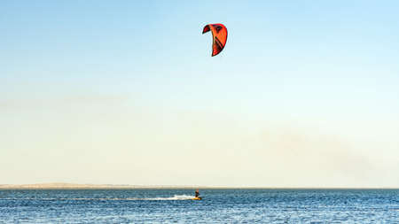Man kitesurfer rides kite. Black Sea coast on sunny day. Blagoveshenskaya. Anapa, Russiaの写真素材