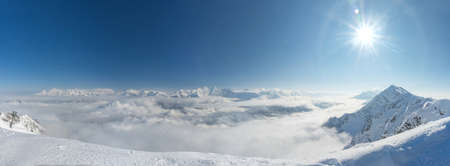 Aerial View above the clouds. Rosa Khutor Ski Resort, mountains covered by snow in Krasnaya Polyana, Russiaの写真素材