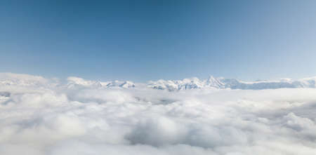 Aerial view from above of clouds. Rosa Khutor Ski Resort, mountains covered by snow in Krasnaya Polyana, Russiaの写真素材