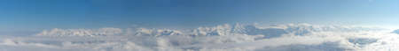 Aerial View above the clouds. Rosa Khutor Ski Resort, mountains covered by snow in Krasnaya Polyana,...