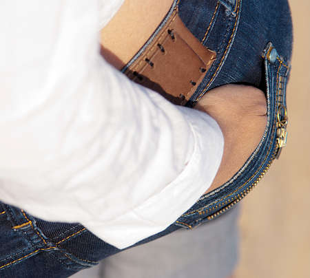 Standing backwards woman with hand in pocket