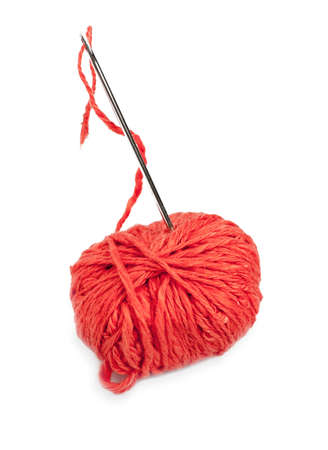 Red thread ball and needle with pink thread isolated on white