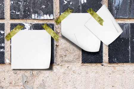 the plastered wall with a ceramic tile and notes paperの写真素材