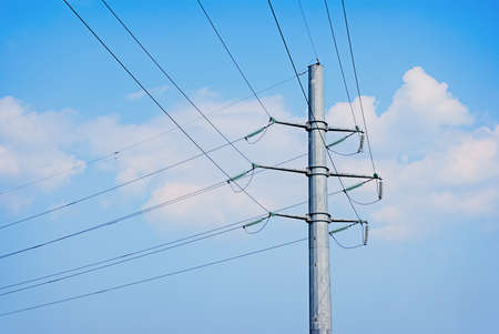 electric wires pole on a background of blue skyの写真素材