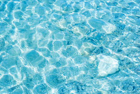 Blue sea water with sunlight reflections の写真素材