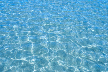 Blue sea water with sunlight reflections 