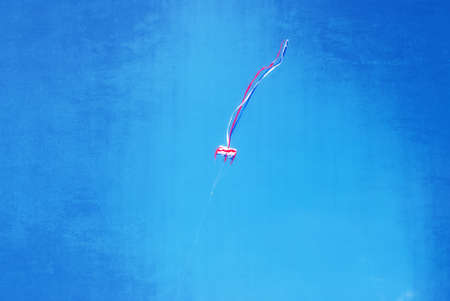 Colorful kite flying in the wind, textured artwork in painting styleの写真素材
