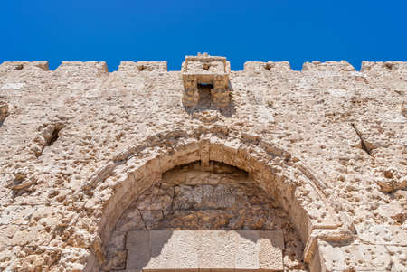 Upper part of Zion Gate, one of the seven gates of the old city of Jerusalem. There are many bullet holes that are clearly seen on the stoneの写真素材
