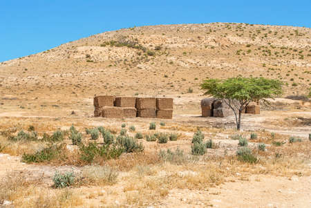 Desert landscape in Israel's Negev desert and bales of hay for animals.の写真素材