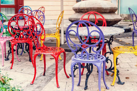 Vintage street Coffee Shop, brightly colored metal chairsの写真素材