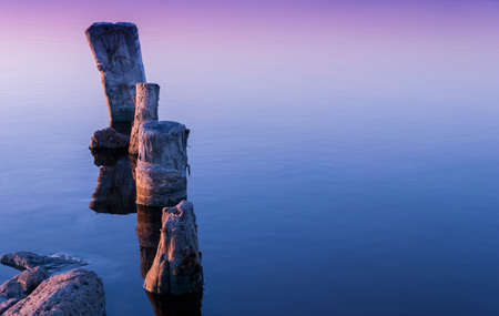 Colorful bright orange blue summer sunset over lakeの写真素材