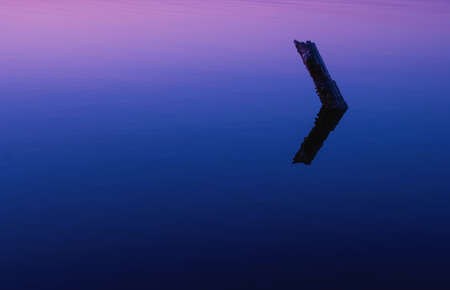 Reflection in the lake colorful bright orange blue sunsetの写真素材