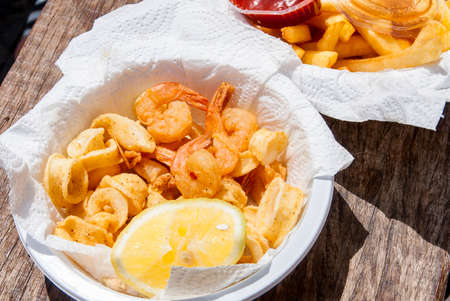 Crispy fresh squid and shrimp in white plate.の写真素材