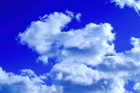 Texture of white clouds floating across the blue sky.