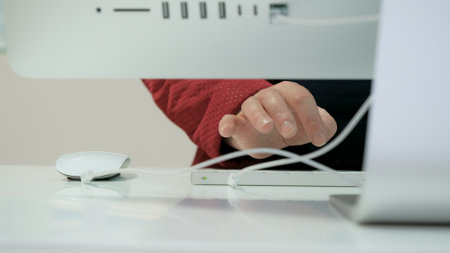 Women hands type on the keyboard of a white PC. Close-up shot