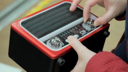 Women hands twist the handles on an old, retro receiver. The concept of vintage items, collecting...