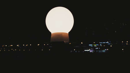 Lanterns on the embankment. In the background, you can see the lights of a large city. It night...