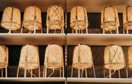 Background, texture of glowing, wooden lamps standing on a shelf. Concept of interior design and decorationの写真素材