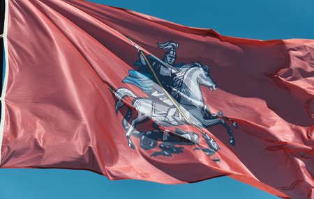 Red flag of Moscow, the capital of the Russian Federation, with the image George Victorious, fluttering in the wind. The concept of national symbols, international relationsの写真素材