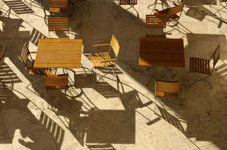 Aerial view of slatted table and chairs with shadows.の写真素材