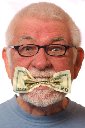 Man with money in mouth signifying expressionの写真素材
